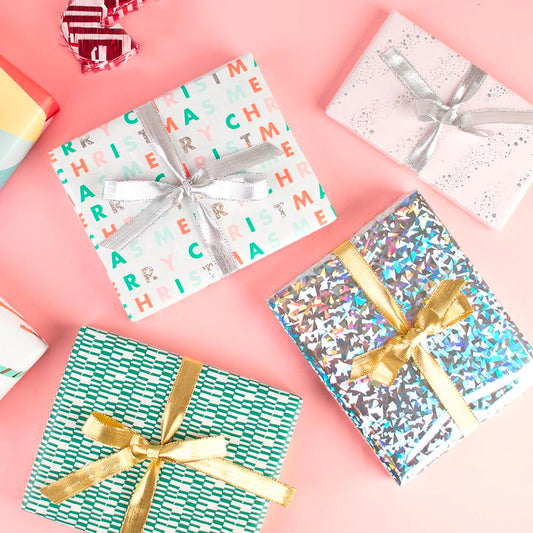 Christmas gift wrapping idea with a selection of gift wrap rolls