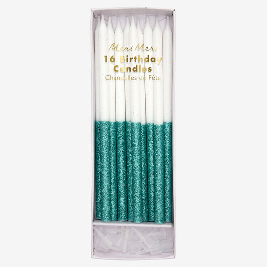 Long turquoise candles with sequins for birthday cake decoration.