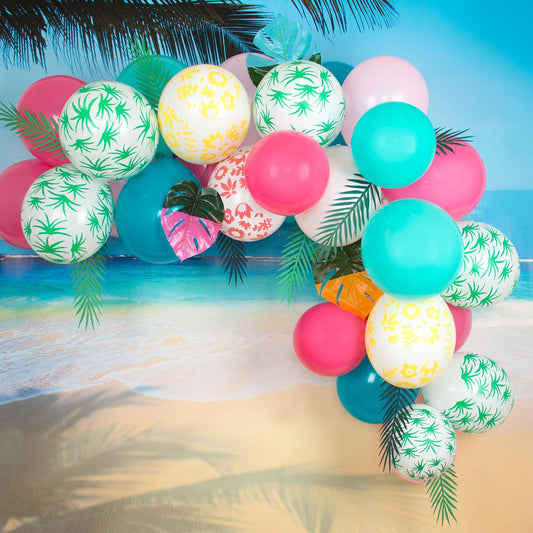 Tropical balloon arch with My Little Day balloons.