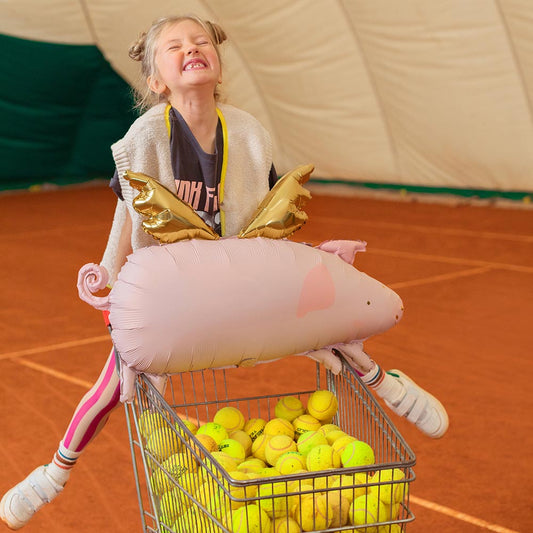 Ballon hélium cochon volant sur terrain de tennis