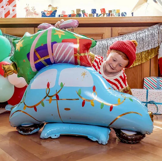 Mylar balloon in the shape of a Christmas themed car for a child's Christmas gift