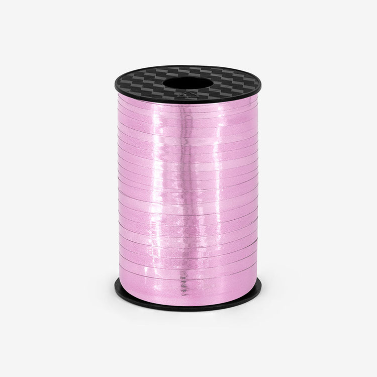 Roll of metallic pink bolduc thread for gift wrapping
