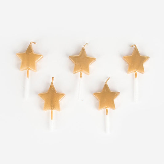 Golden star candles for birthday cake decoration.