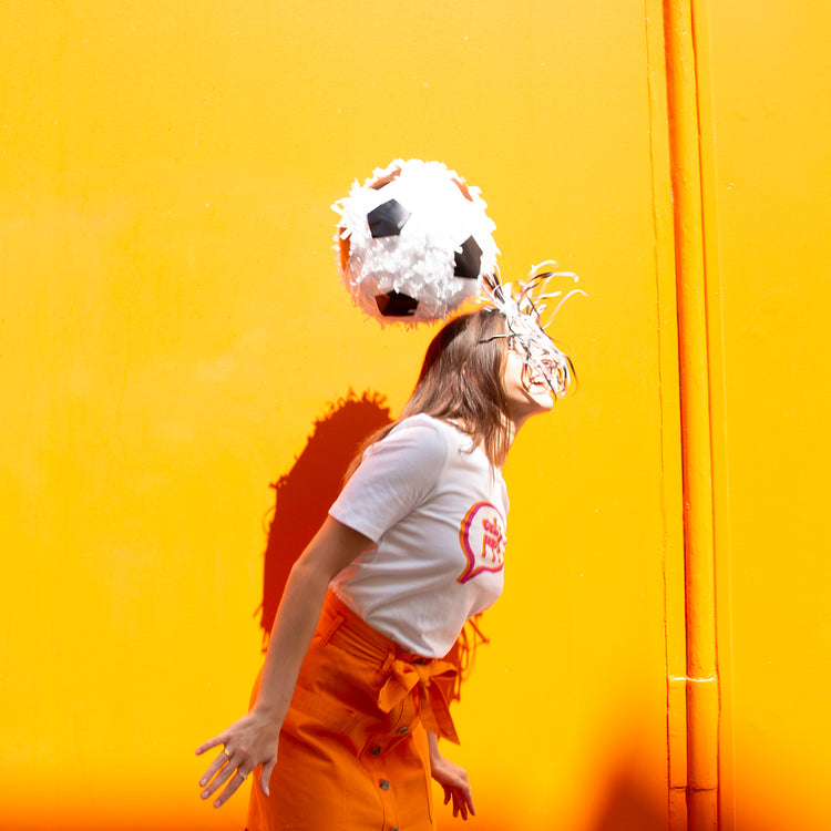 Una piñata de balón de fútbol para animar una fiesta de adultos con temática deportiva.