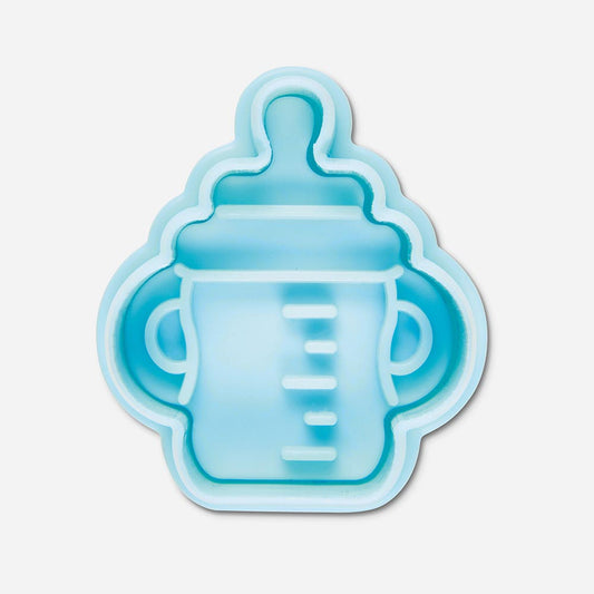 Gender reveal party: cookie cutter in the shape of a baby bottle for cake