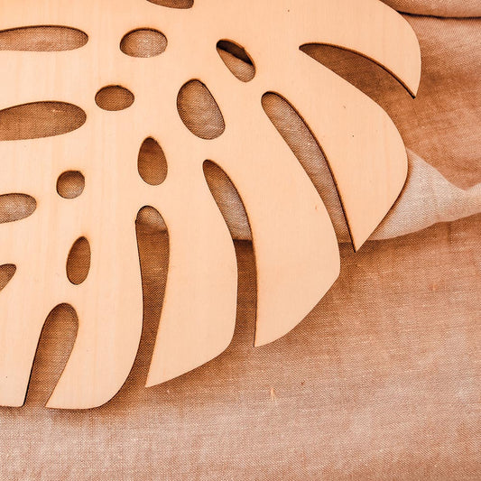 Nature tropical table decoration detail: wooden monstera leaf