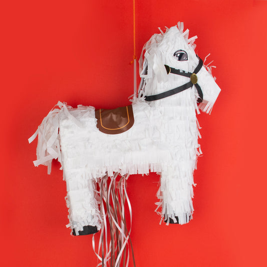 Pinata a forma di cavallo bianco per ravvivare la festa di compleanno di un bambino.