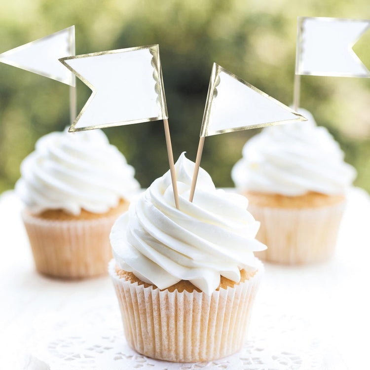 White cupcakes with white and gold flag toppers for wedding decor